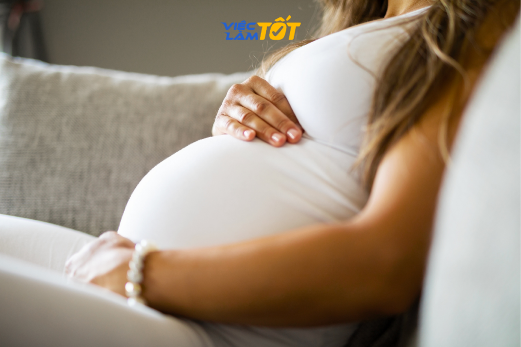 Mẹ bỉm sữa làm việc tại nhà với máy tính và em bé bên cạnh