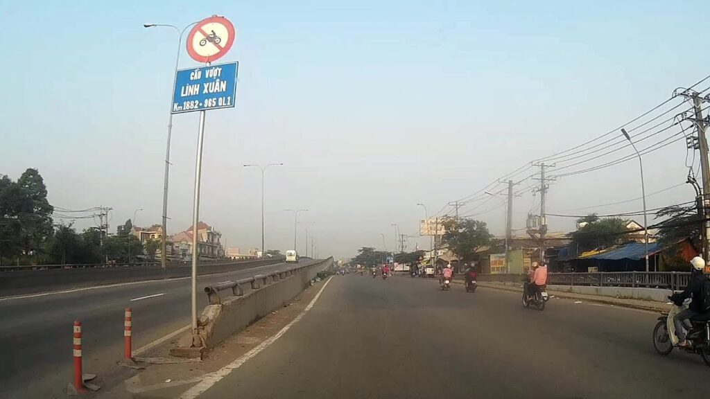 Cầu vượt Linh Xuân Thủ Đức trên Quốc lộ 1A với làn đường dành cho xe cộ và bảng chỉ dẫn giao thông.