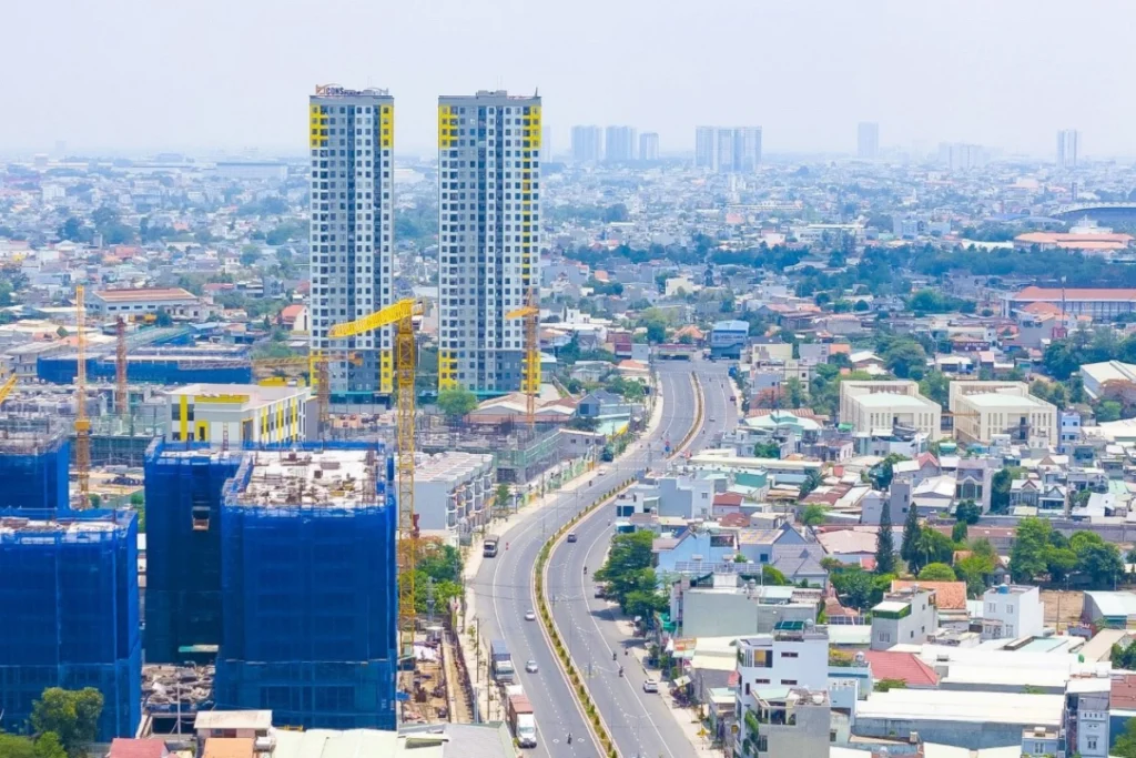 Toàn cảnh không gian đô thị hiện đại nhìn từ trên cao với một trục lộ lớn có dải phân cách cây xanh chạy dọc trung tâm