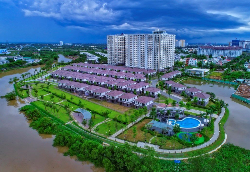 Hình ảnh thực tế chụp từ trên cao khu căn hộ Flora Fuji Quận 9 kết nối liền mạch với khu biệt thự mái ngói nâu, công viên ven sông và hồ bơi ngoài trời