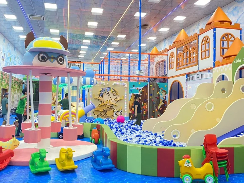 Khu vui chơi trẻ em trong nhà với bể bóng lớn cầu trượt lâu đài và vòng quay ngựa gỗ sắc màu